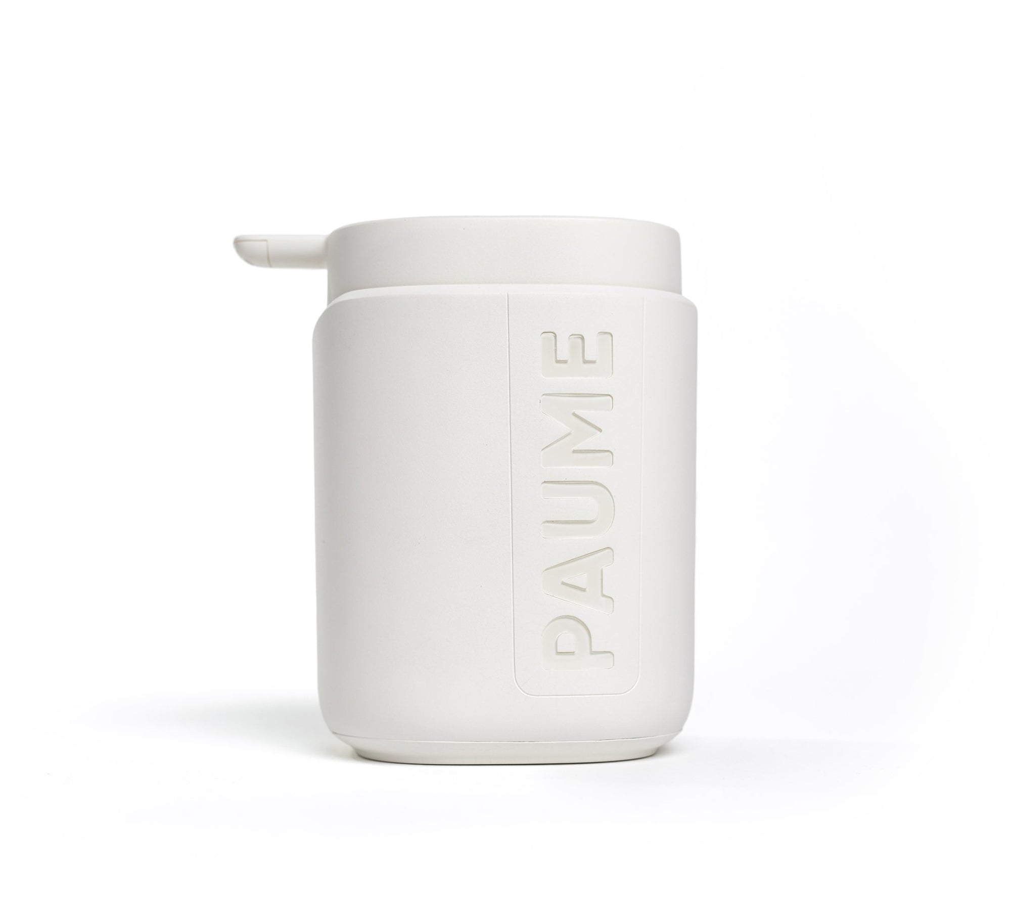 A white pump bottle with the brand name 'paume' printed on it, against a beige background.
