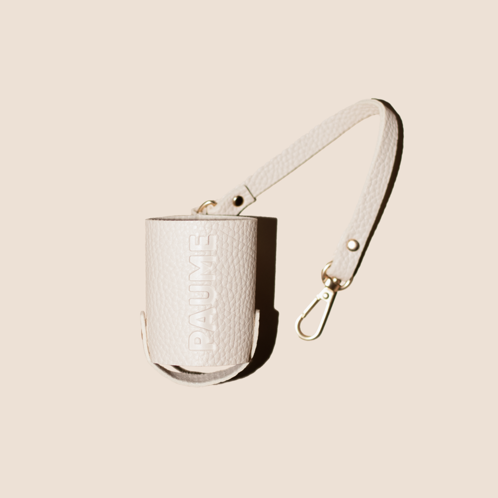White textured handbag with a strap on a beige background
