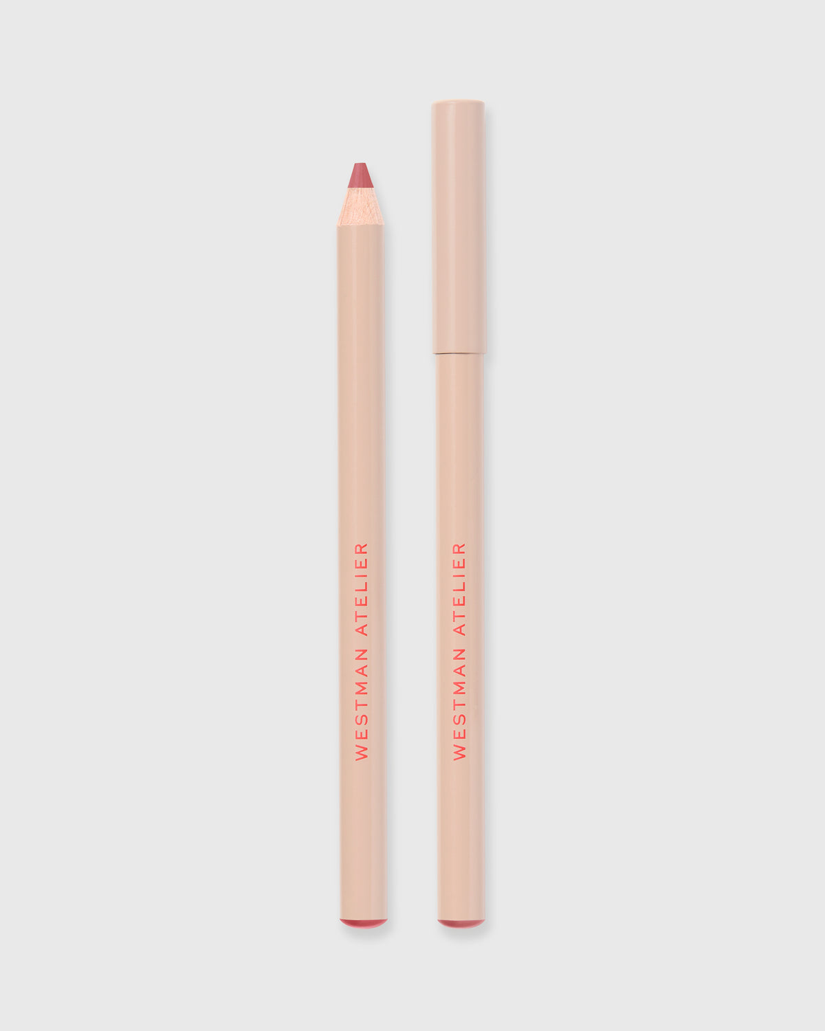 Two lip pencils from Westman Atelier on a light gray background
