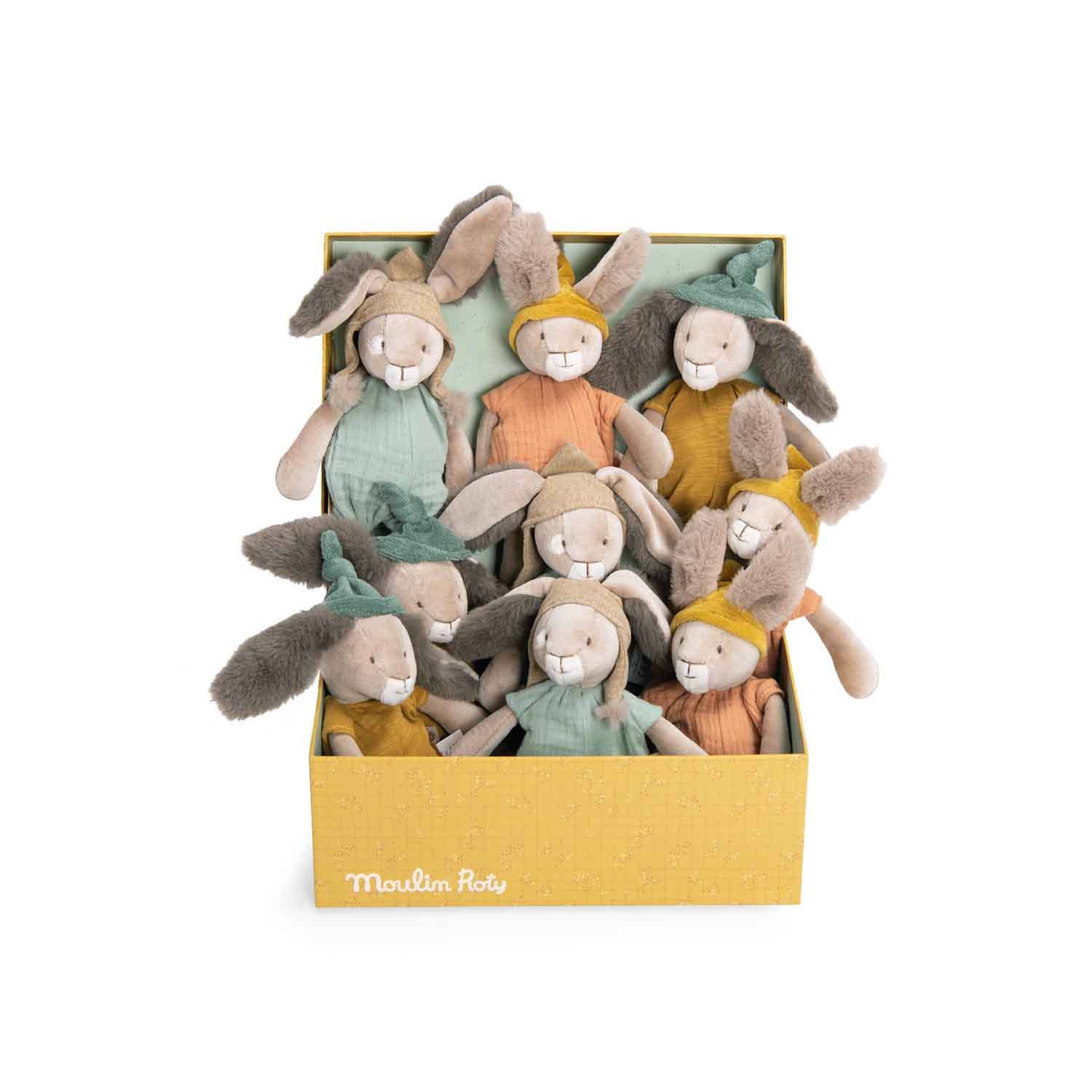 A display box filled with various colored stuffed toy rabbits, each wearing a jersey or muslin romper suit.