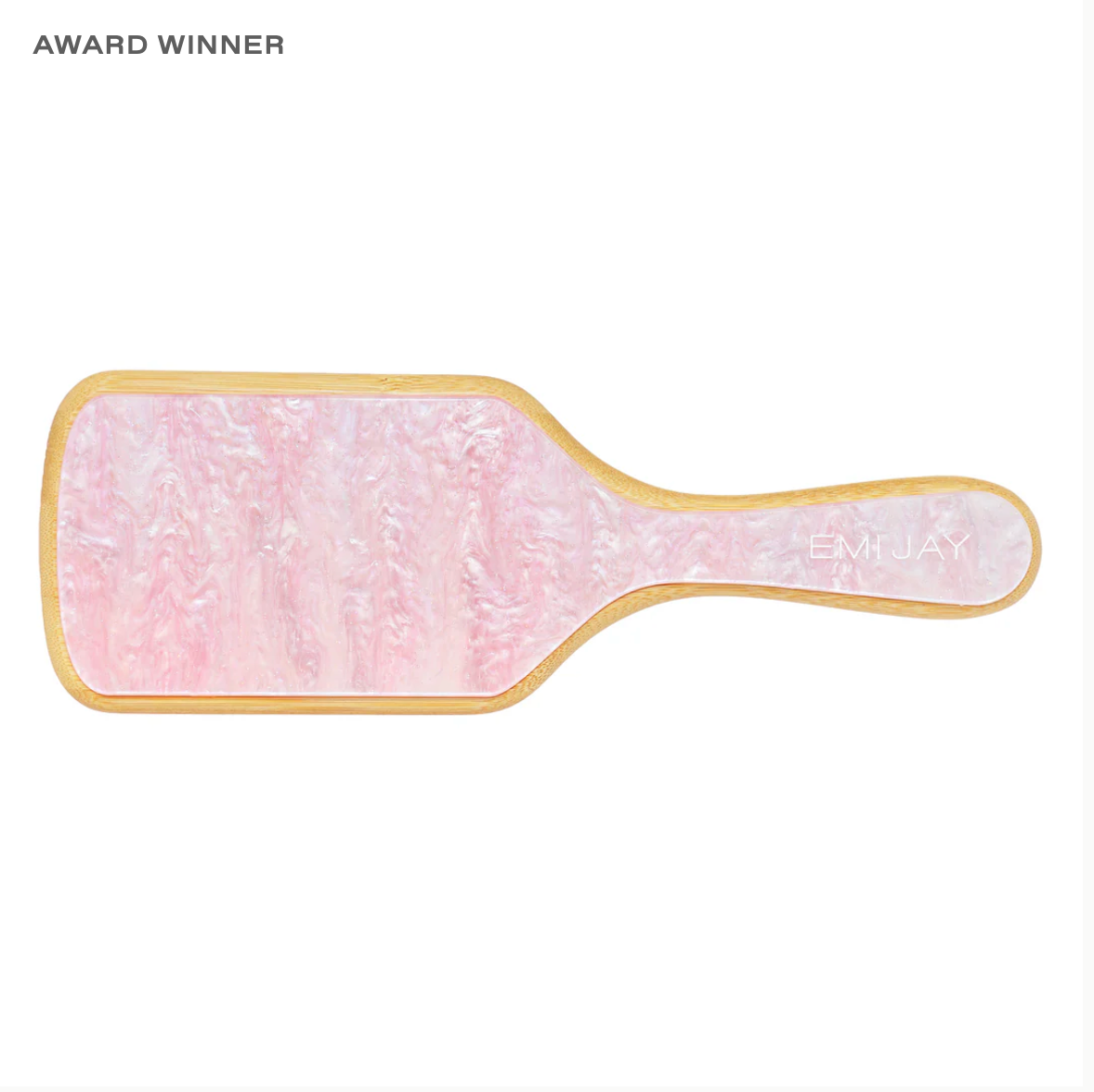 A pink pearl paddle brush with the words "award winner"