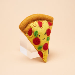 A handmade felt pizza slice dog toy, made by Gone to the Dogs in Brooklyn