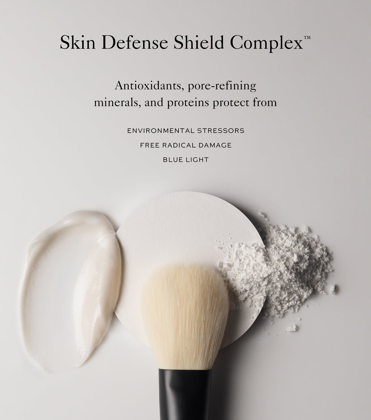 Cosmetic product with a brush and powder on a light background, featuring text about Skin Defense Shield Complex.