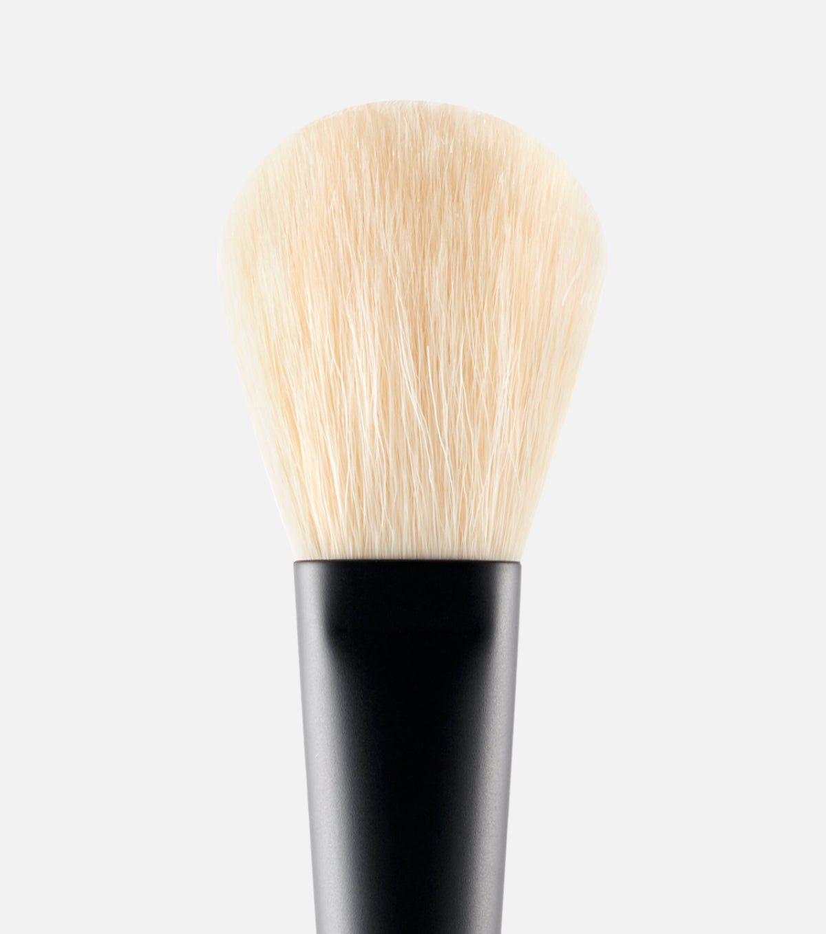 Makeup brush with black handle and white bristles on a light gray background