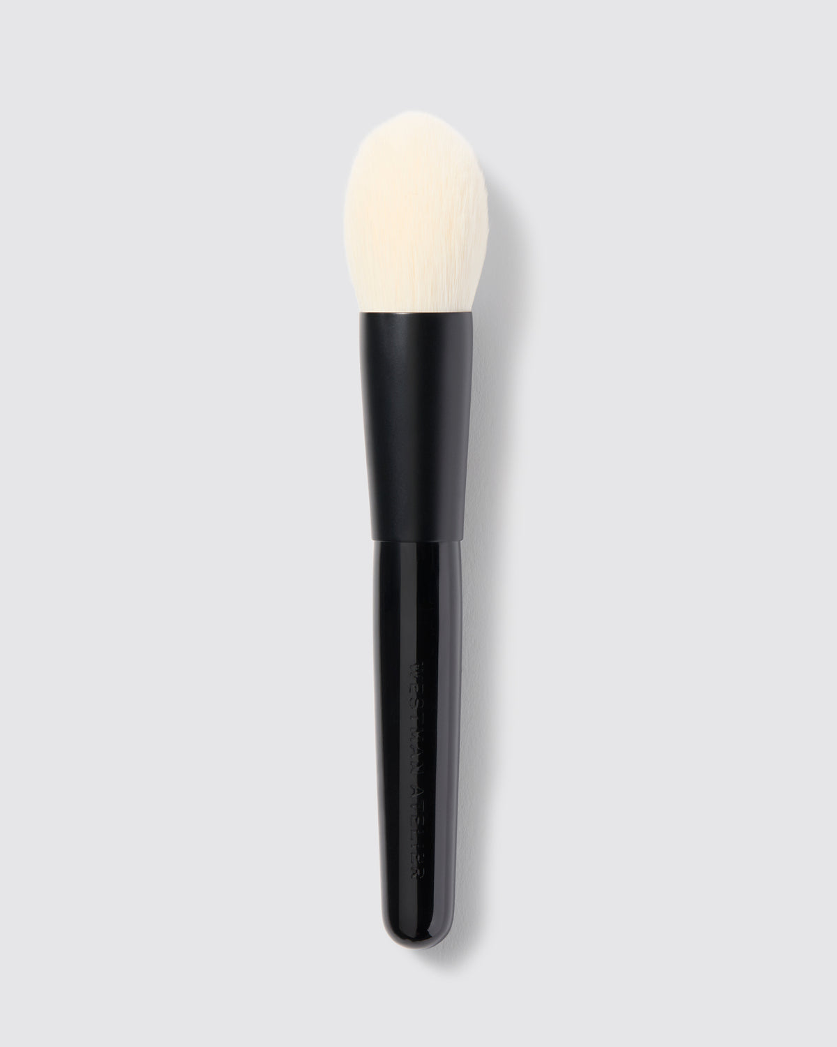 A tapered powder brush with a black handle and white bristles, designed for precise application of powder products.