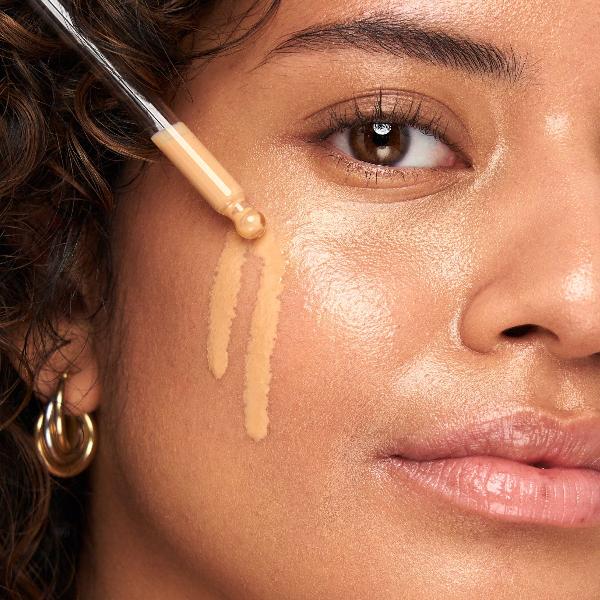 A woman applying the Indie Lee SPF 50 primer to her face