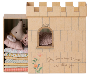 A toy playset featuring a castle with a princess mouse and a pea, inspired by 'The Princess and the Pea' fairytale. The set is primarily beige and includes a bed with mattresses.