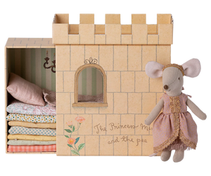 Cardboard castle toy with a mouse princess doll on a white background