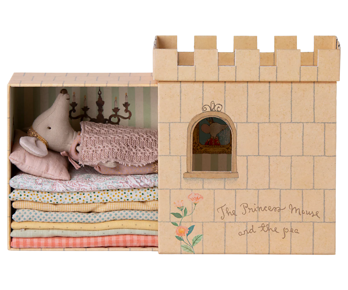 Cardboard castle toy with plush toys inside, featuring 'The Princess Mouse and the pea' text.