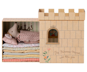 Cardboard castle toy with plush toys inside, featuring 'The Princess Mouse and the pea' text.