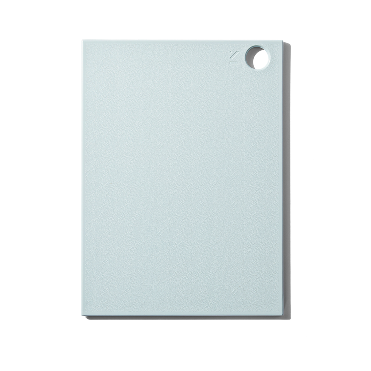 A solid teal recycled plastic cutting board with a textured surface and a small hole in the corner.