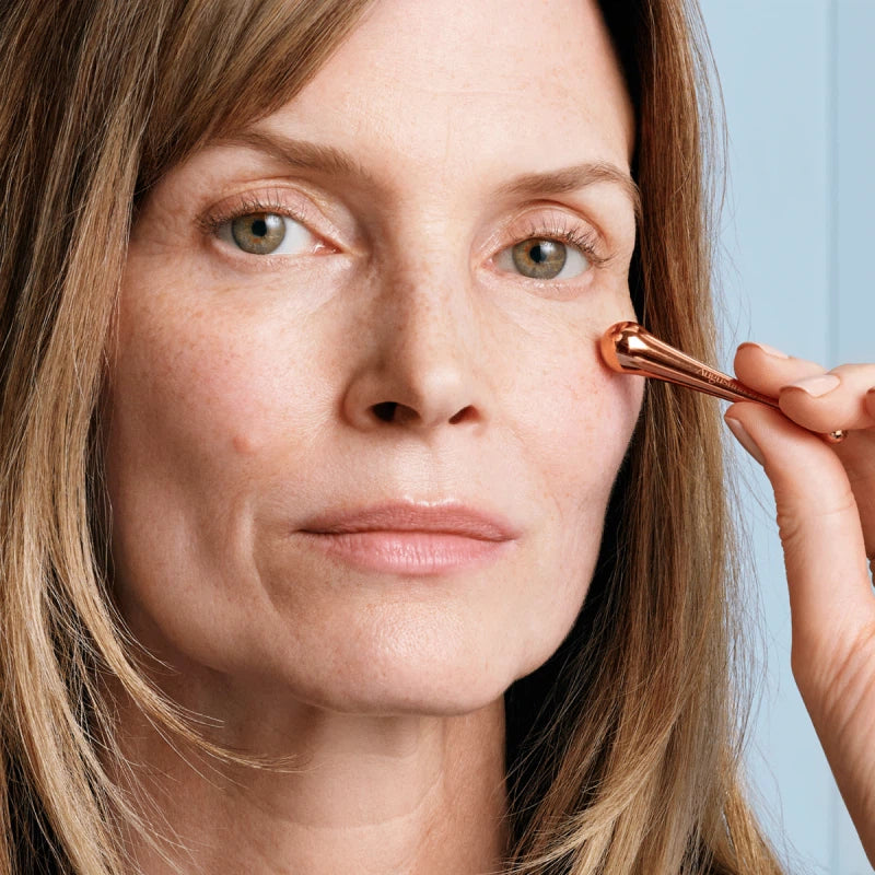 Woman applying the rich eye cream 