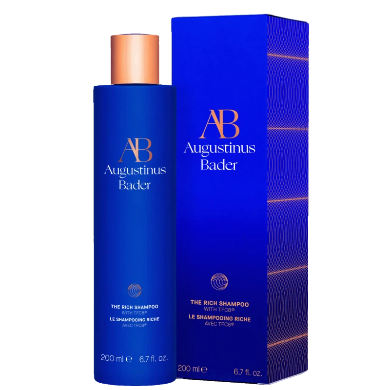 A blue bottle of the rich shampoo with a copper cap