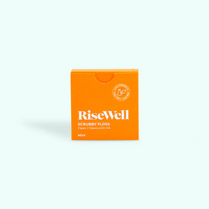 Orange box of RiseWell scrubbie floss on a white background