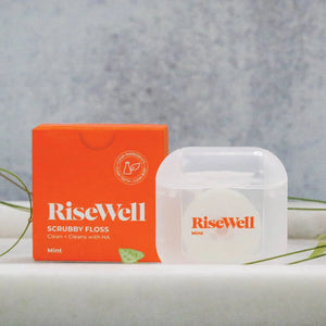 RiseWell scrubby floss box and container on a gray background