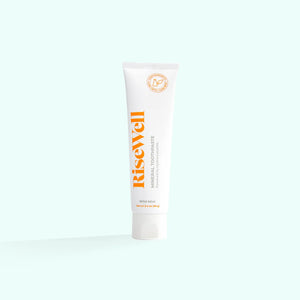 A tube of RiseWell Mineral Toothpaste with orange and white color scheme on a white background.