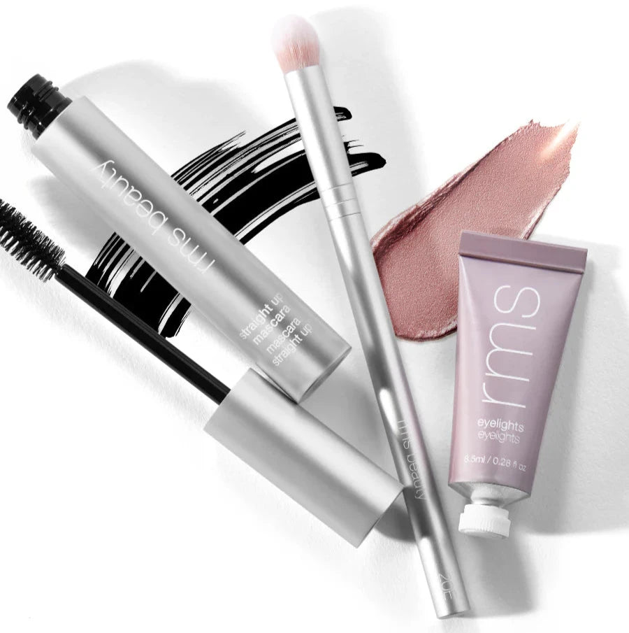 A silver makeup brush on a white background. 