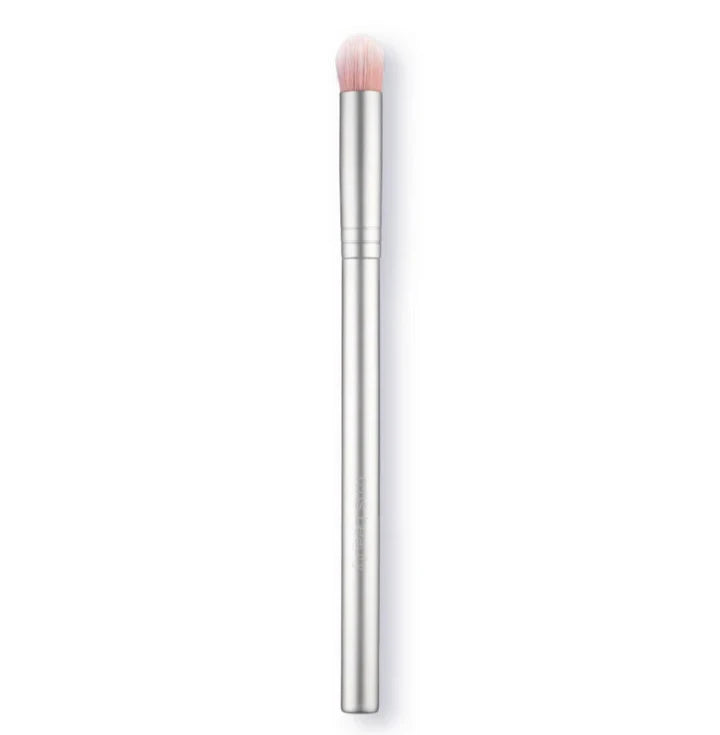 A silver makeup brush on a white background. 