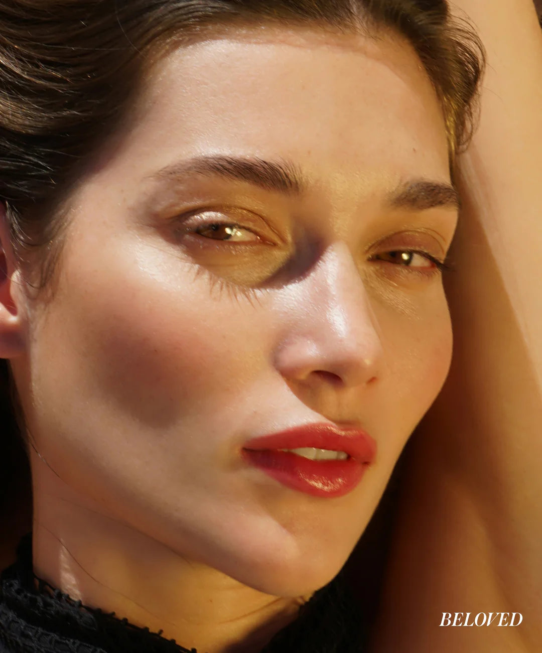 Close-up of a woman's face with 'BELLOVED' branding.