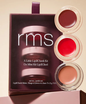 RMS Beauty lip and cheek kit with three shades in front of its packaging.