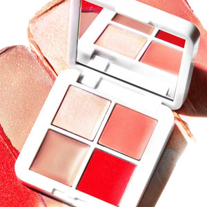 A white compact with four different makeup colors in it. 