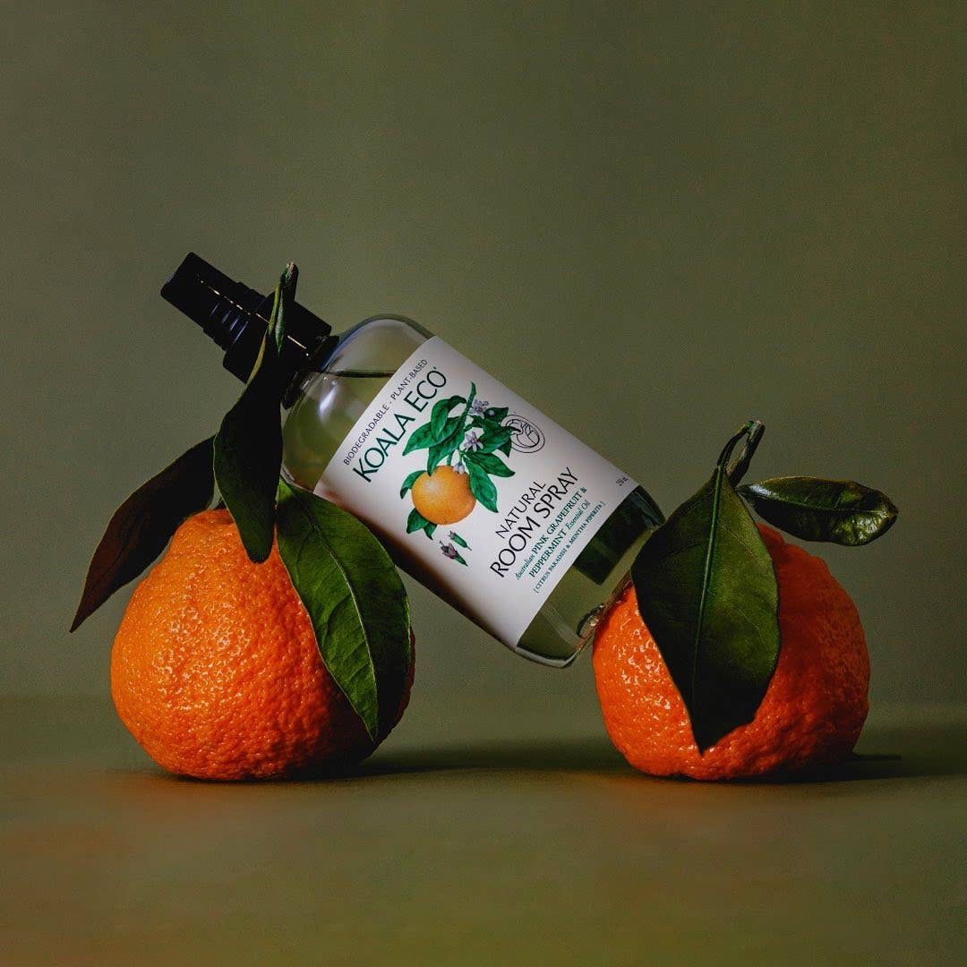 A bottle of the organic Koala Eco room spray on top of two oranges
