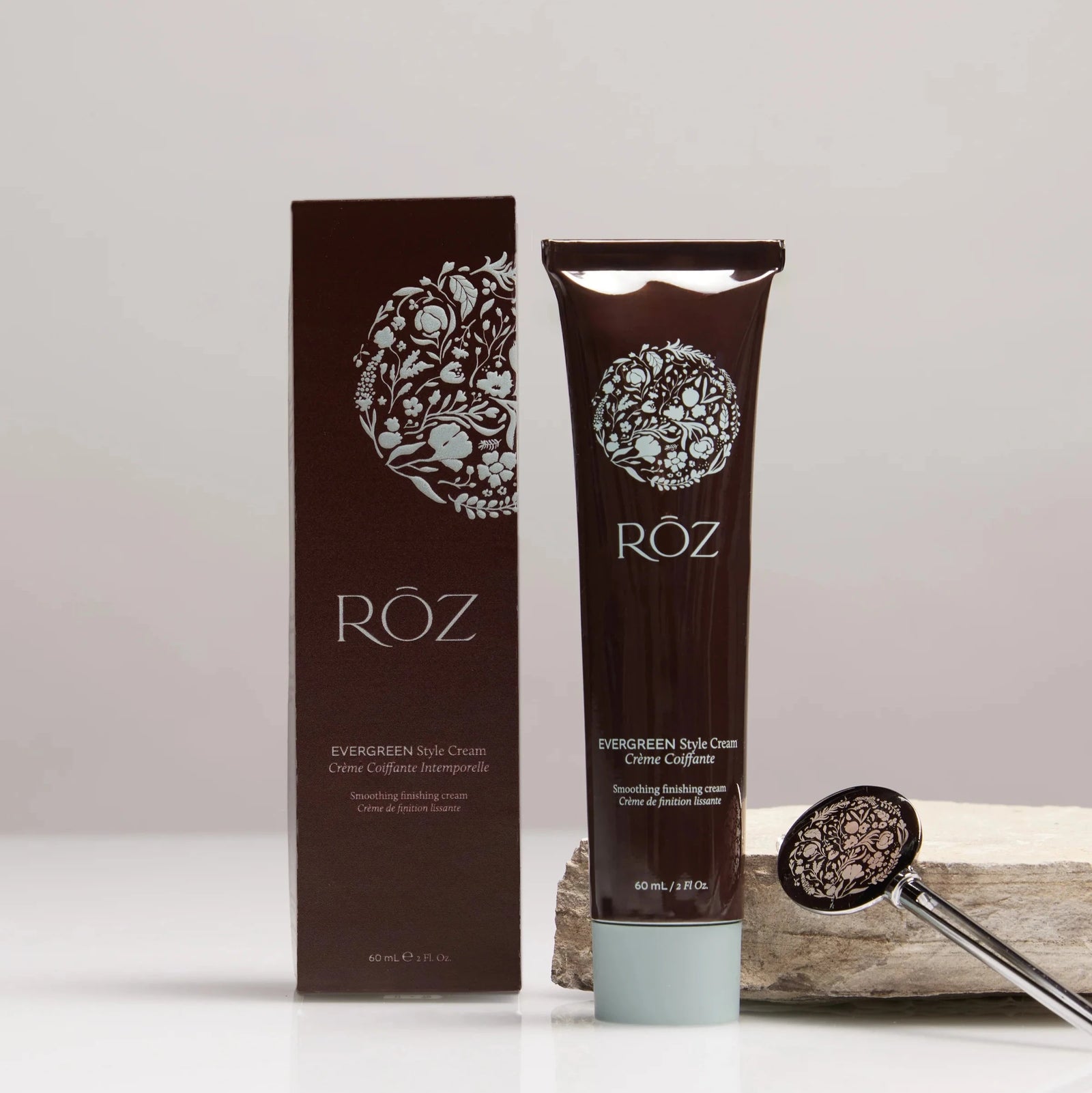 The ROZ Evergreen styling cream, sitting next to a brown box and a tube key