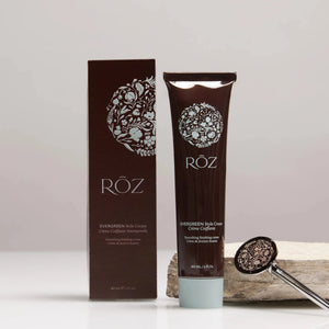 The ROZ Evergreen styling cream, sitting next to a brown box and a tube key
