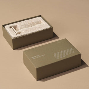 A green safety razor box. 