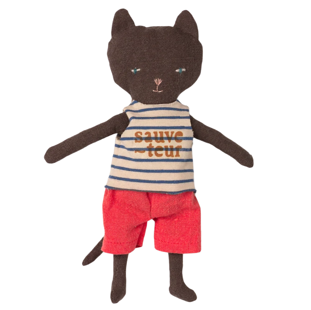 Stuffed toy cat wearing a striped shirt and red shorts on a white background