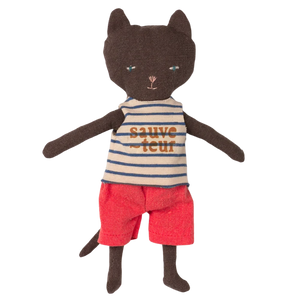 Stuffed toy cat wearing a striped shirt and red shorts on a white background