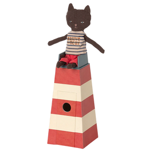 Cat-shaped toy on a striped red and beige tower with a white background