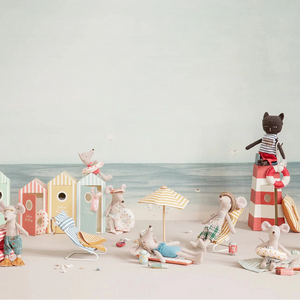 Set of miniature beach-themed figures and accessories on a light background