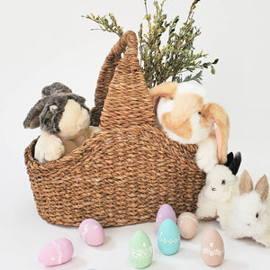 Savar Handwoven Picnic Basket with stuffed animal bunnies and some greenery. 