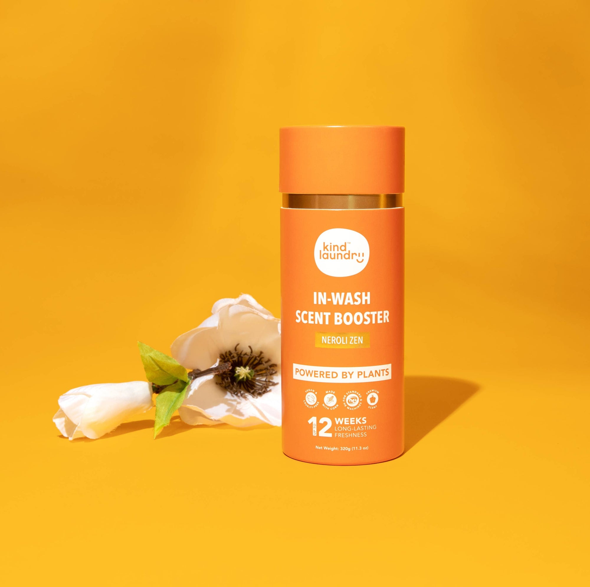 A bottle of Kind Laundry scent boosters on an orange background. 