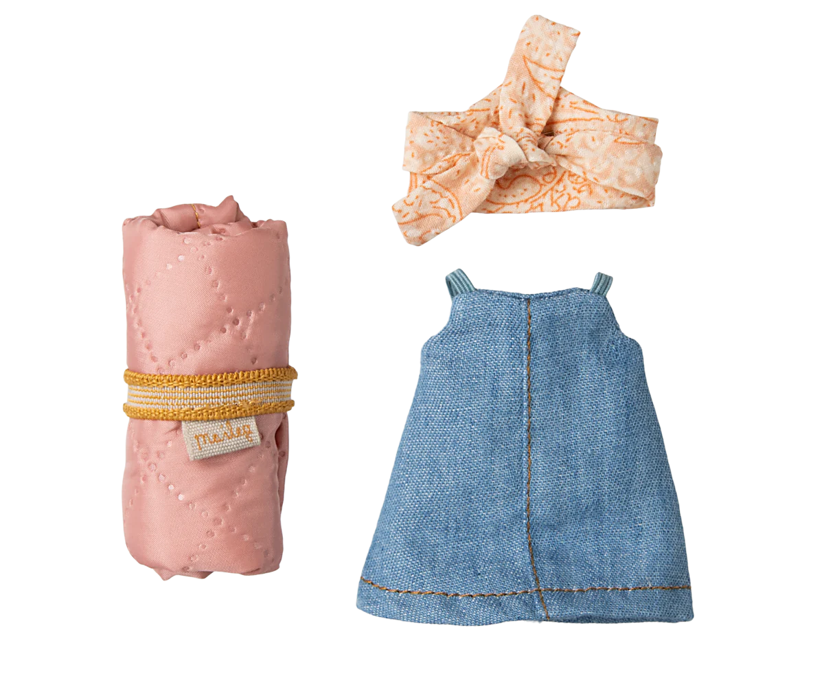 Baby dress, pink blanket, and headband on a white background