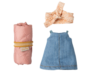 Baby dress, pink blanket, and headband on a white background