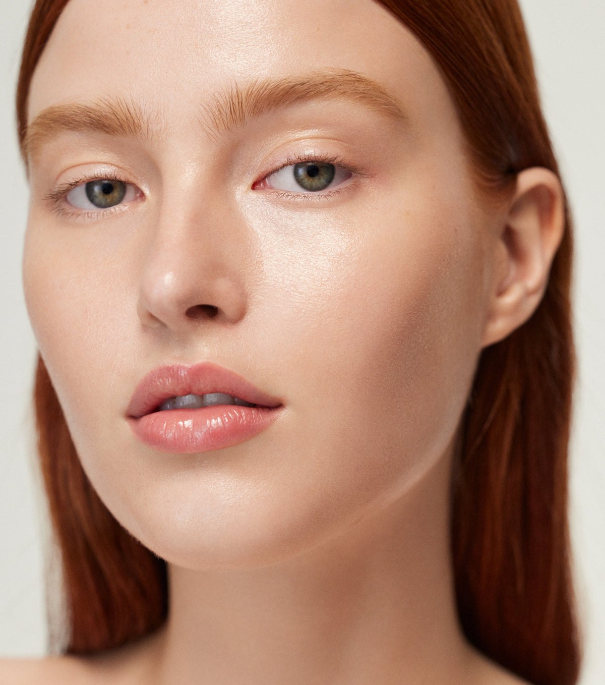 Close-up of a person with a neutral expression on a plain background