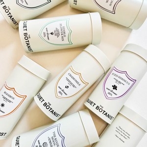 Collection of 'Quiet Botanist' skincare products on a light background