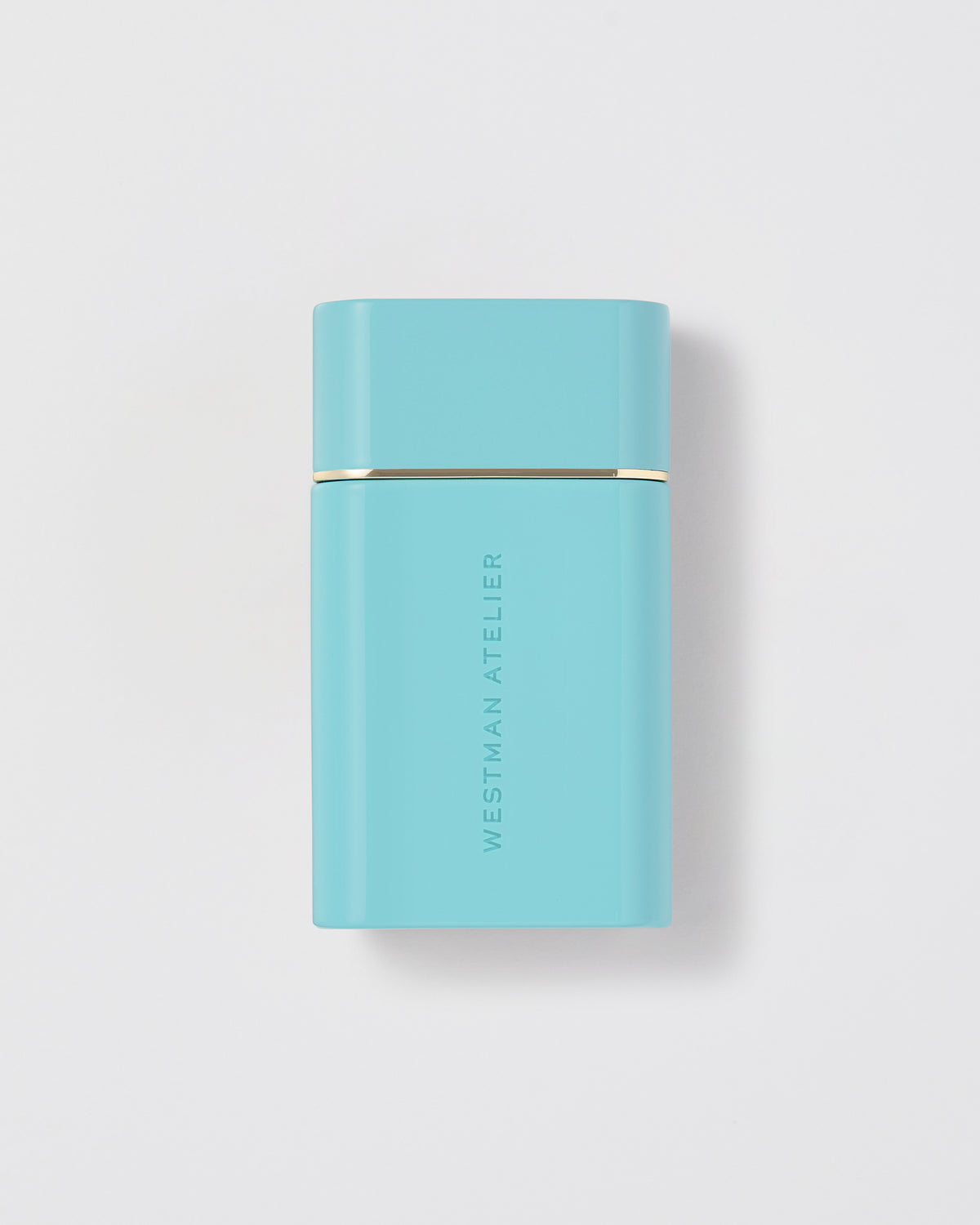 Turquoise rectangular product with gold accent on a light gray background