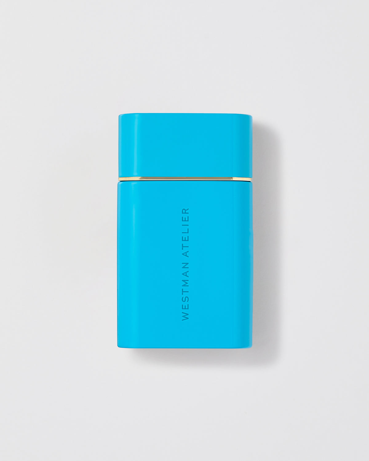 Turquoise rectangular product with gold accent on a light gray background