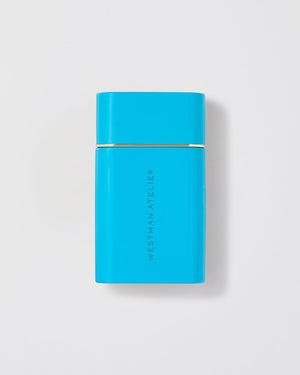 Blue rectangular product with 'Westman Atelier' branding on a light gray background