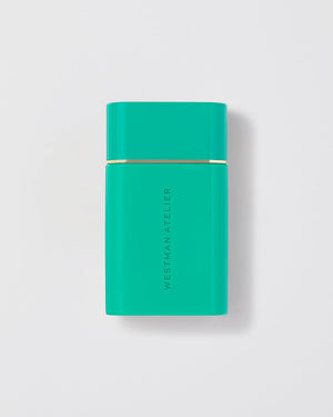 Turquoise rectangular product with gold accent on a light gray background