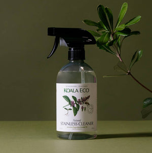 A bottle of Koala Eco Stainless Cleaner with a light green background and a leafy branch