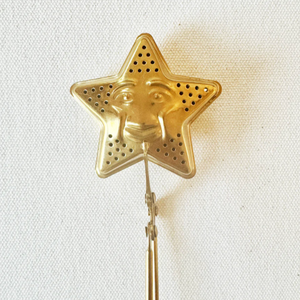 Gold star-shaped object on a white background