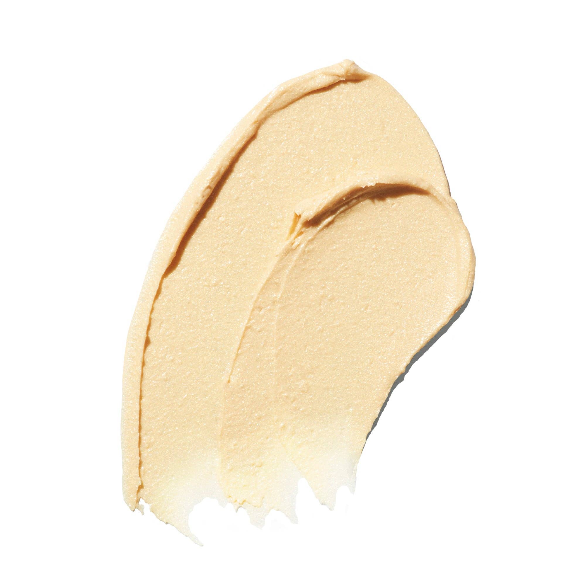 Cosmetic stick with beige cap and gray body on a white background, featuring 'Indie Lee' branding.