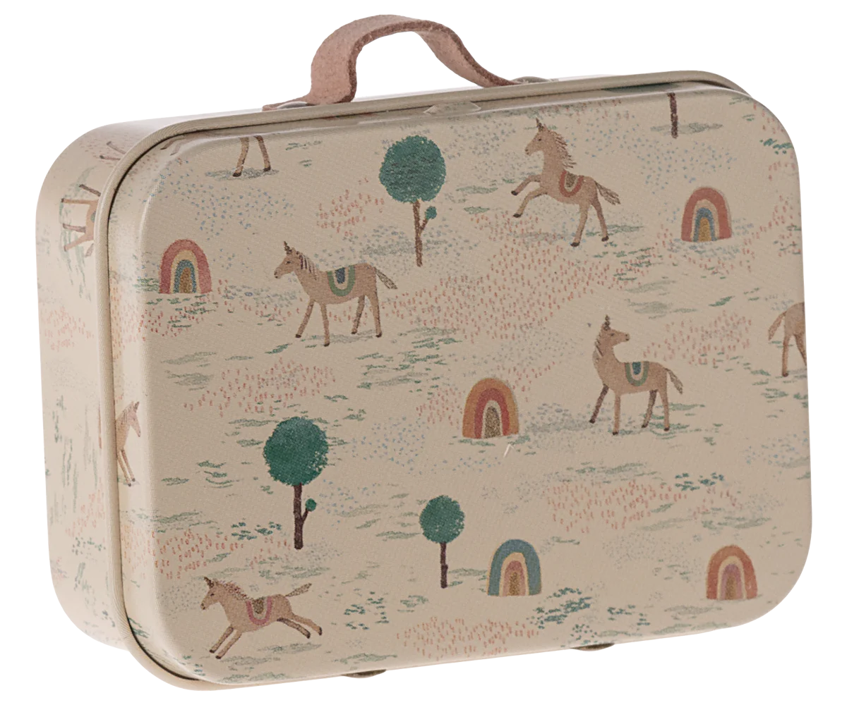 A small metal suitcase with a beige background featuring colorful illustrations of unicorns, horses, trees, and rainbows.