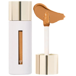 Cosmetic concealer with applicator and swatch on a white background