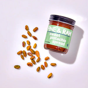 A jar of Fine and Raw sweet pistachio spread with pistachios