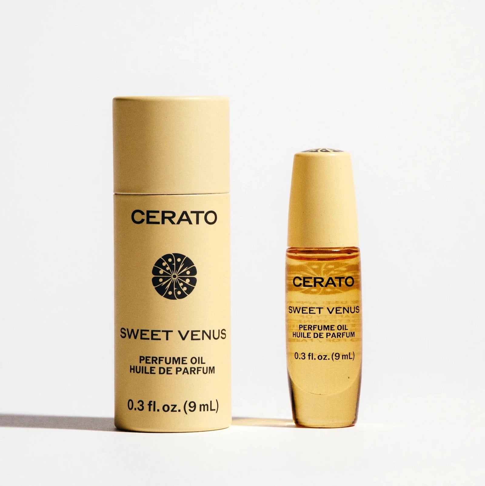 Two bottles of Cerato Sweet Venus perfume oil on a light background